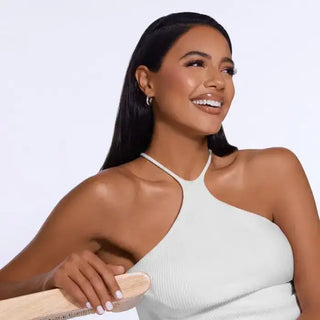 White ribbed tank top with halter neckline and wooden paddle brush